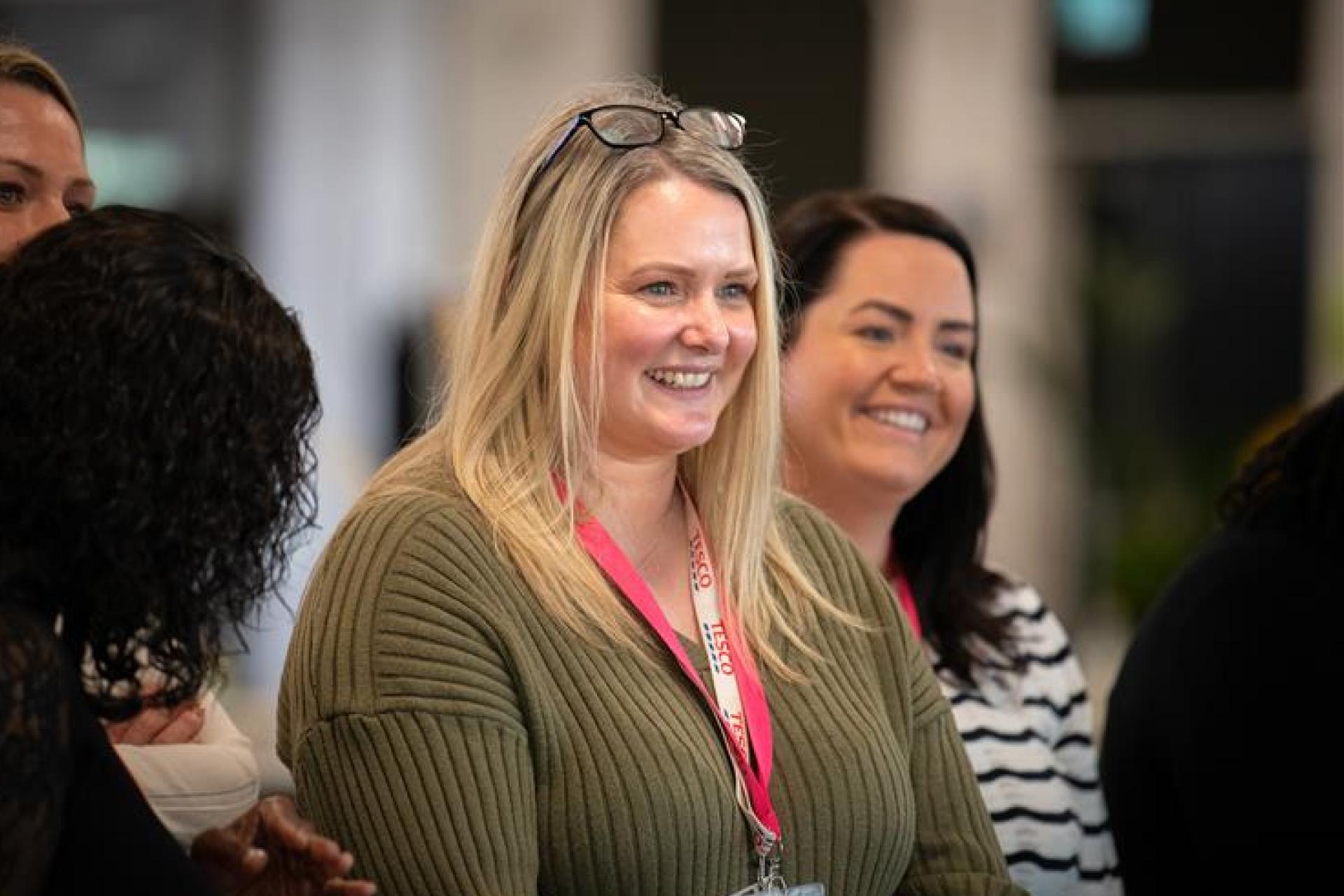 Female colleague smiling at an event