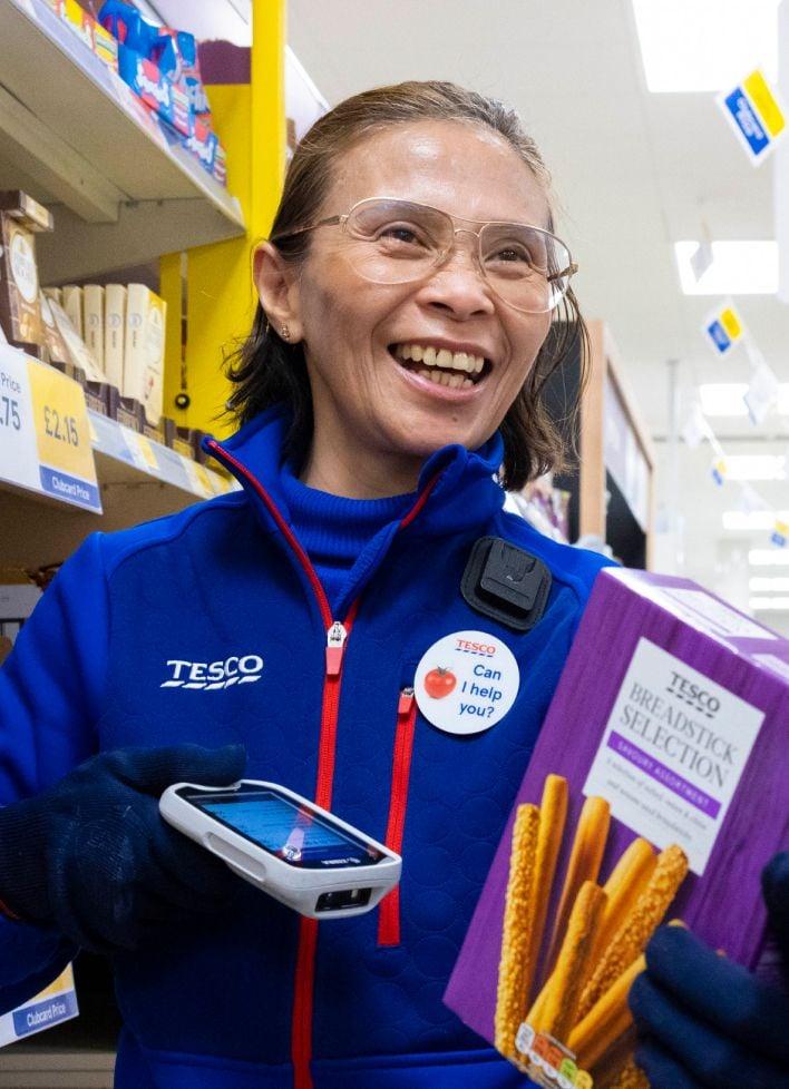 Female store colleague scanning breadsticks