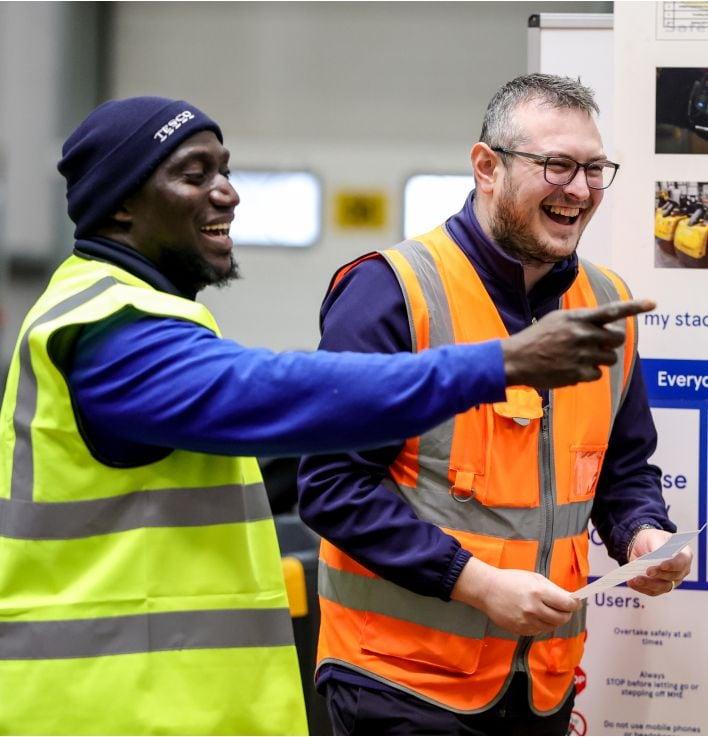 Two male distribution colleagues laughing